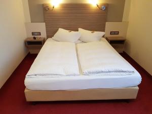 Postel nebo postele na pokoji v ubytování Hotel Mühleneck