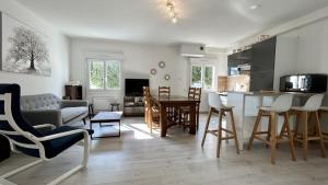 a kitchen and living room with a table and chairs at L'Appart de nos 2 vies in Le Crotoy