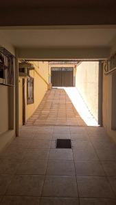 an empty hallway with a tile floor in a building at Pousada Colonial in Macaé
