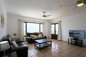 a living room with a couch and a tv at Villa Lise - 3 Bedroom private pool child friendly in Tías