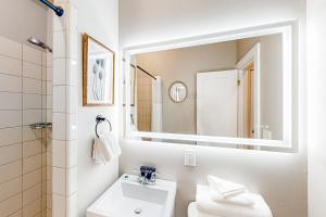 a bathroom with a sink and a mirror at The Brick Junction #2 in Seattle