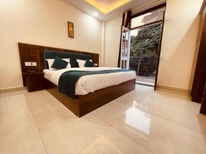 a bedroom with a large bed and a large window at The Divine Ganga - Top Rated and Most Awarded Property In Haridwar in Haridwār