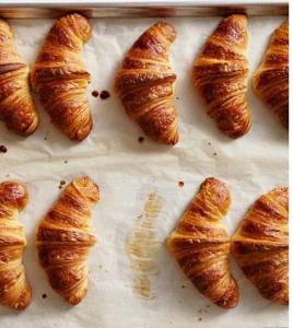 a group of croissants sitting on a baking sheet at Luxury Designer Villa by the Beach Bright Beautiful Brand New in Galveston