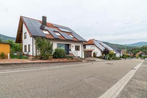 a house with solar panels on the roof at Haus Gartenblick in Annweiler am Trifels