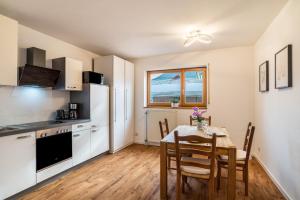 a kitchen and dining room with a table and chairs at Haus Gartenblick in Annweiler am Trifels