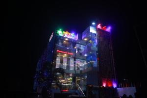 a building with christmas lights on it at night at Hotel The Heaven in Muzaffarpur