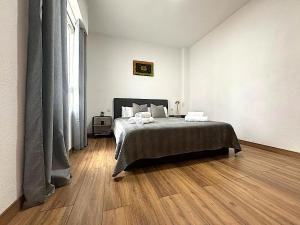 a bedroom with a bed and a wooden floor at Santa Pola port, sea view in Santa Pola