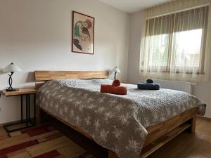 a bedroom with a large bed with two pillows on it at Strand Apartmant in Keszthely