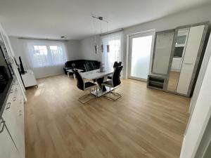 a living room with a table and chairs at Apartment Dußlingen 