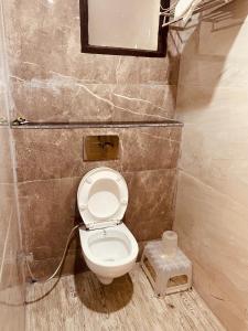 a small bathroom with a toilet in a room at The Divine Ganga - Top Rated and Most Awarded Property In Haridwar in Haridwār