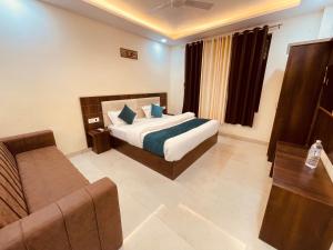 a bedroom with a bed and a couch in a room at The Divine Ganga - Top Rated and Most Awarded Property In Haridwar in Haridwār