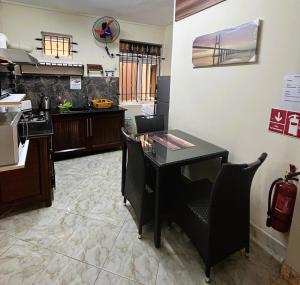 a kitchen with a table and chairs in a room at Apartment Huz Peer 1 in Triolet