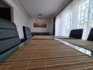 a conference room with a long table and chairs at SmartHomeApartman in Hajdúszoboszló