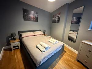 a bedroom with a bed with towels on it at Fantastic and modern city centre flat with FREE parking! in Cardiff