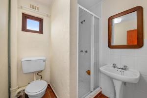 a bathroom with a toilet and a sink and a mirror at San Lameer Villa 2015 - Three bedroom Classic - 6 pax - San Lameer Rental Agency in Southbroom