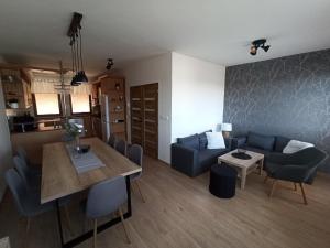 a living room with a blue couch and a table at Apartmán Vendelínka in Valtice