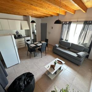 a living room with a couch and a table at Espectacular departamento a estrenar en Mendoza in Godoy Cruz