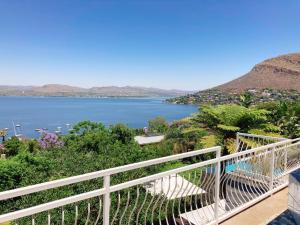 a view of a lake from a balcony at Mister C in Hartbeespoort