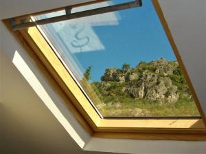 a window with a view of a mountain at Les Studios de St Guilhem in Saint-Guilhem-le-Désert