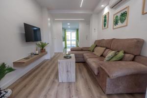 un soggiorno con un divano e una TV di 085 - Gaviotas 005 - comfortHOLIDAYS a Santa Pola