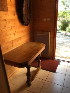 a wooden table sitting in the corner of a room at chalet de la haute fontaine in Anould