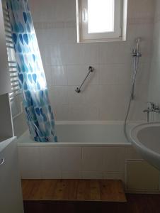 a bathroom with a bath tub and a sink at Apartment Krnov in Krnov