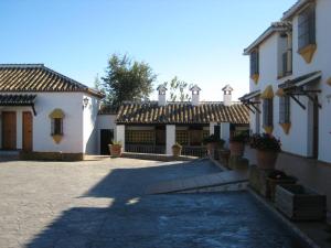 a courtyard of a white building with a roof at 3 bedrooms house with shared pool and wifi at Hornachuelos in Hornachuelos