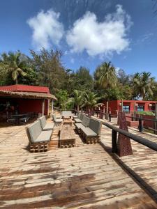 a row of lounge chairs on a wooden deck at Hotel le Trarza in Niaga