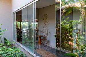 a glass door leading to a patio with a table at Spa Agua Milagrosa in Cuiabá