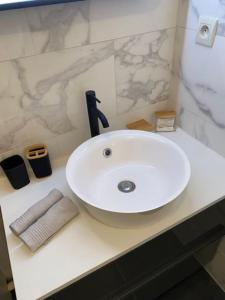 a bathroom sink with a faucet on a counter at Mulhouse grand T2 -  La Fonderie -Parking gratuit in Mulhouse
