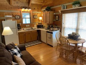 a kitchen with a couch and a table in a room at Home Sweet Home Cabin in Cosby