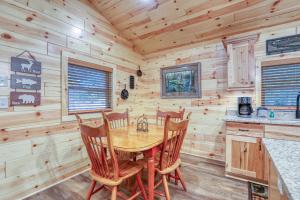 a dining room with a table and chairs in a log cabin at Beside Still Water 2 - 2 Bedrooms, 2 Baths, Sleeps 6 home in Cosby
