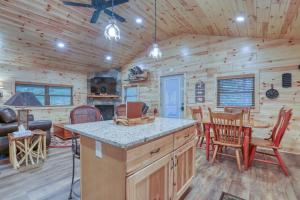 a log cabin kitchen and dining room with a table and chairs at Beside Still Water 2 - 2 Bedrooms, 2 Baths, Sleeps 6 home in Cosby
