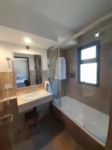 a bathroom with a sink and a shower at Hotel Las Cascadas in La Cumbrecita