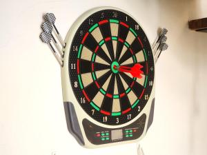 a dartboard on a wall with two darts at Loft Suite Seaview JB CIQ 7Pax in Johor Bahru
