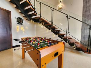 a foosball table in front of a staircase at Loft Suite Seaview JB CIQ 7Pax in Johor Bahru