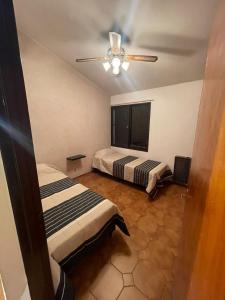 a bedroom with two beds and a ceiling fan at Quinta Don Benito - Chacras de Coria- in Ciudad Lujan de Cuyo
