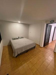 a bedroom with a bed in a white room at Quinta Don Benito - Chacras de Coria- in Ciudad Lujan de Cuyo