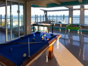 a pool table in a room with a view of the ocean at View Beach in Villa Gesell
