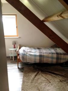 a bedroom with a bed in the attic at Maison de 2 chambres avec vue sur la ville jardin clos et wifi a Dainville in Dainville