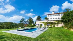 a villa with a swimming pool and a house at VILLA BOEMIA 10, Emma Villas in Alessandria