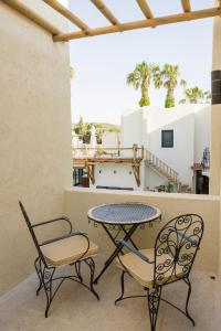 a patio with two chairs and a table and chairs at Bitez Corner Boutique Hotel in Bitez