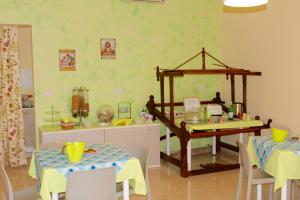 a dining room with two tables and a mirror at B&B La Sciuscitta in Morciano di Leuca