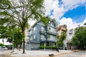 a blue building on a city street at F-APARTMENT in Ho Chi Minh City