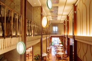 a view of a restaurant with tables and chairs at Due Torri Hotel in Verona