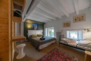 a large bedroom with two beds and a staircase at Grande Maison Creuzier - Villa 3 chambres et jardin in Creuzier-le-Neuf