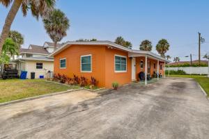 an orange house with palm trees in the driveway at St Pete Beach Retreat about 5 Mi to Sunset Beach Bar in St Pete Beach