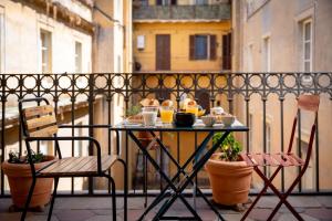 a table with food and drinks on a balcony at Hotel Oceania in Rome