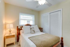 a bedroom with a bed and a window at St Pete Beach Retreat about 5 Mi to Sunset Beach Bar in St Pete Beach