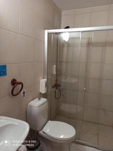 a bathroom with a shower and a toilet and a sink at Lefkara Hotel in Pano Lefkara